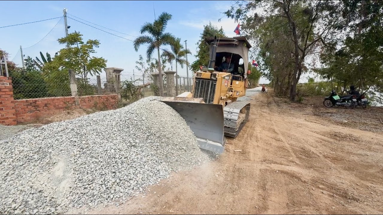 Processing build foundation road spreading gravel by skill dozer d31 with 12wheel dump truck