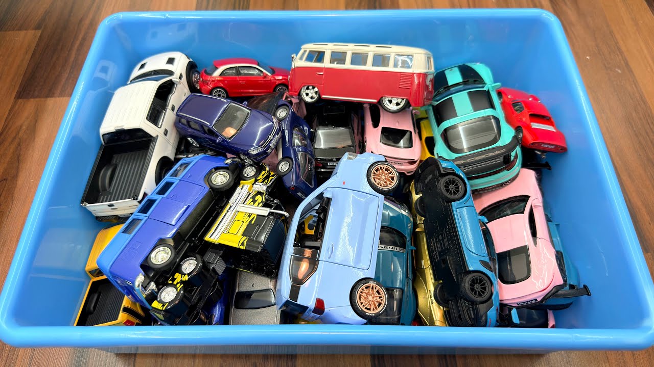 Smaller And Bigger Diecast Model Cars Shown From A Blue Box Volkswagen, Ford, Porsche, Aston Martin 