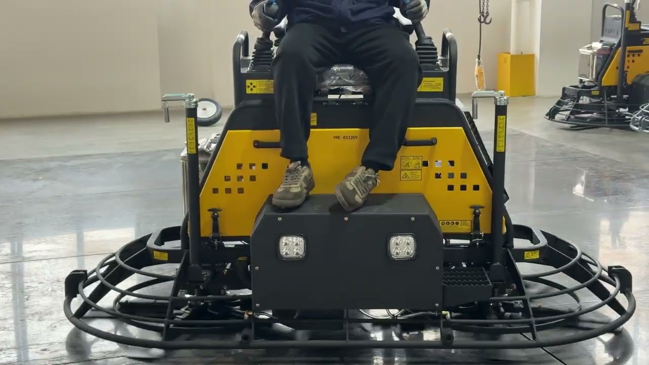 Testing the hydraulic-powered ride-on power trowel.