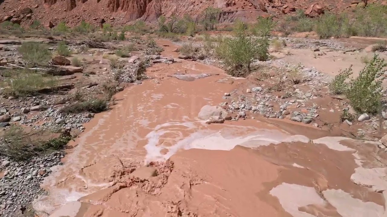 Stock Video - Flying over muddy flood waters through the Utah desert after rainstorm