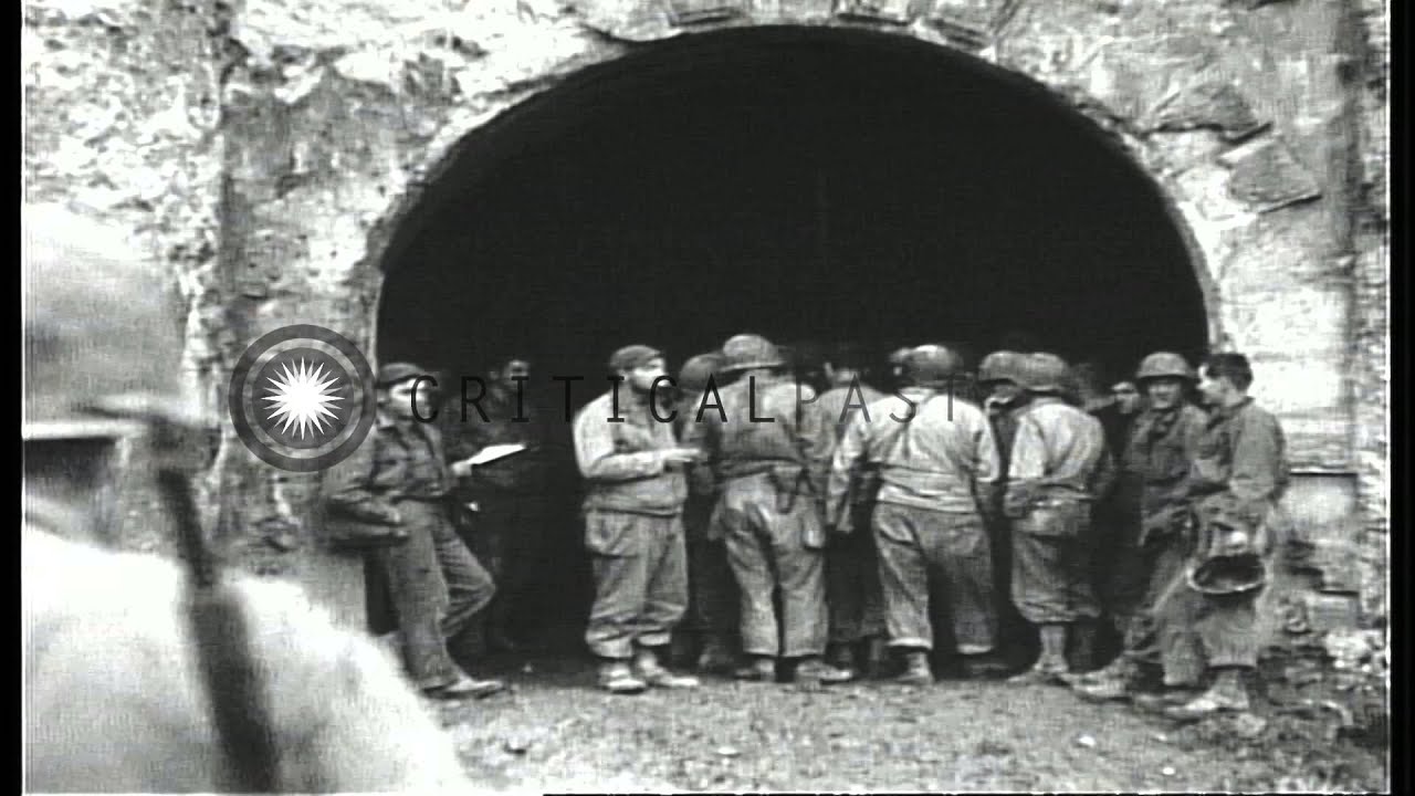 US soldiers walk through the ruins of Fort Manonviller in France during World War...HD Stock Footage
