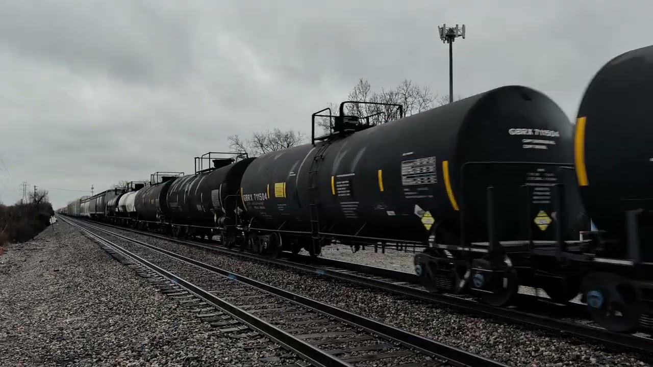 An AC44C6M locomotive hauling a long manifest train with an ES44DC DPU.