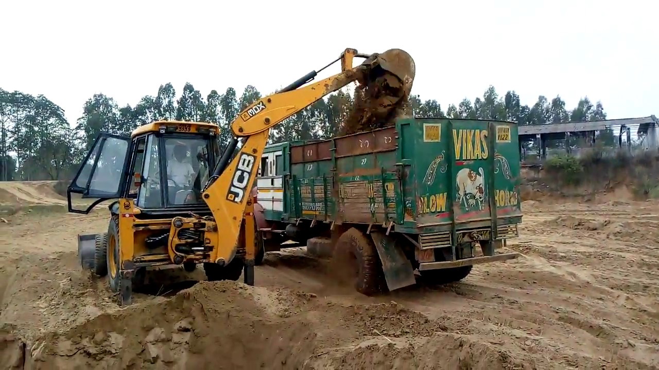 JCB loading soil in tata truck