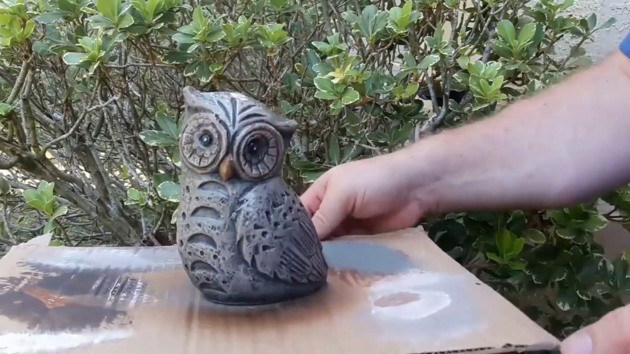 Painting a concrete statue to look like aged stone.