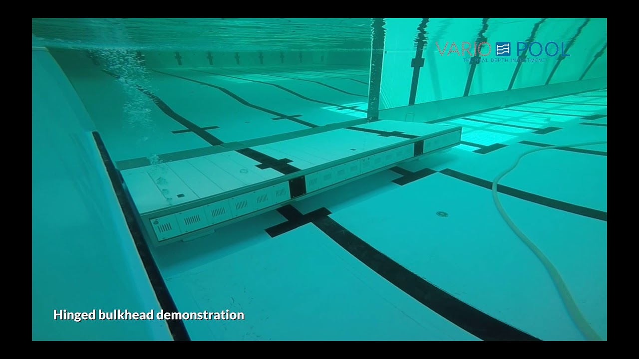 Hinged bulkhead swimming pool
