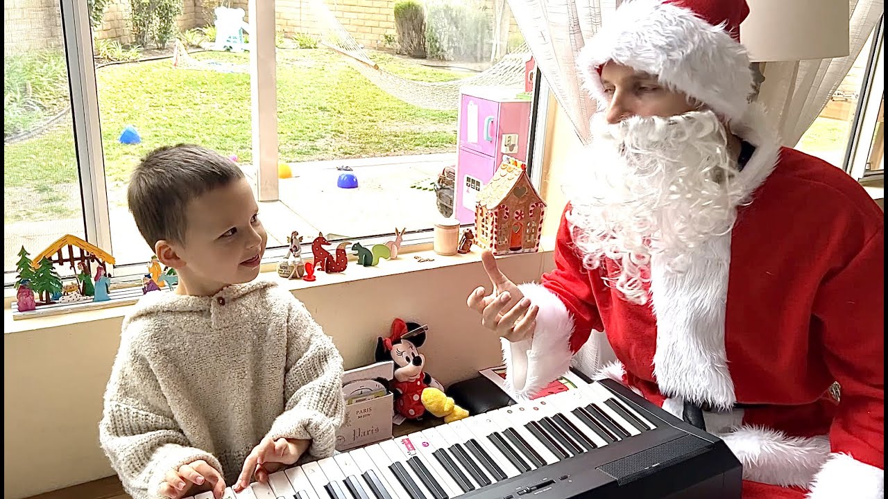 3-year-old brings tears to Santa's eyes playing his favorites songs