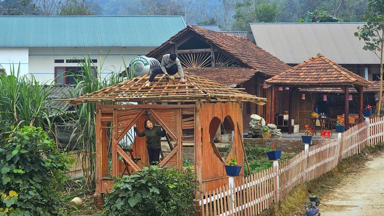 KONG & NHAT work together to restore the abandoned hut by the stream.