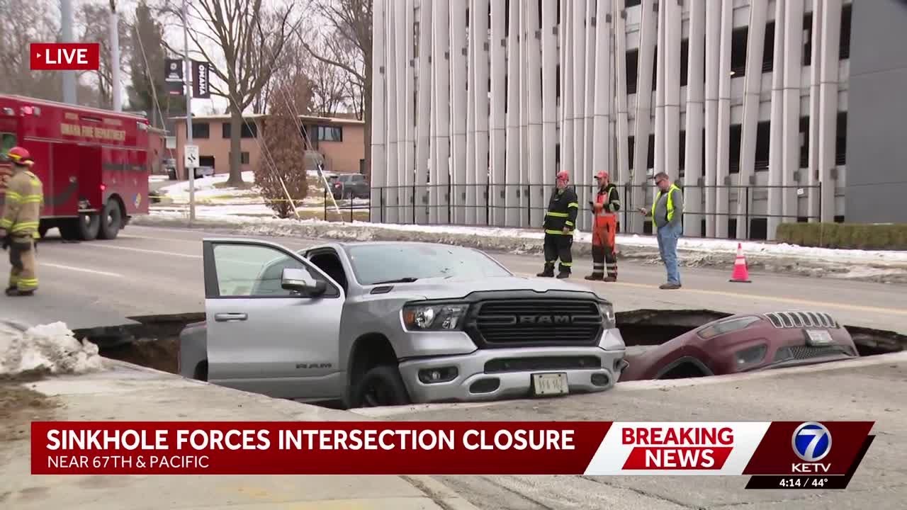 Two vehicles stuck in sinkhole on Pacific Street after road 'collapsed,' Omaha police say
