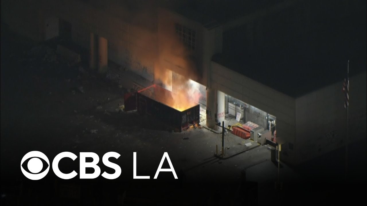 Small group lights dumpster fire outside federal building in downtown LA