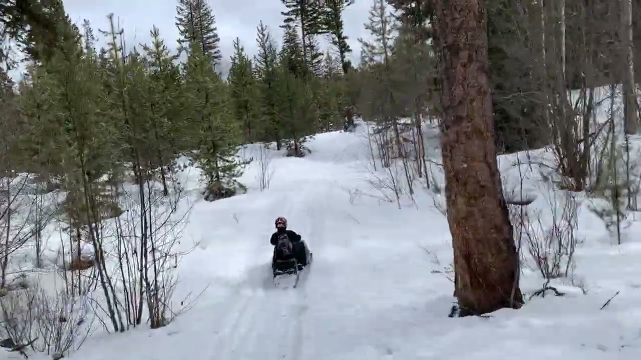 Men sledding on snowmobiles - KCC men's outing March 2023