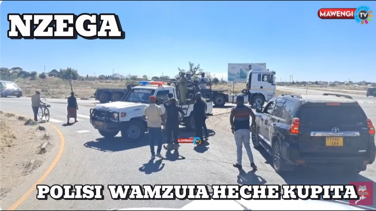 POLISI NZEGA MJINI WALIVYO ZOZANA NA MSAFARA WA HECHE KISA BARABARA YA KUPITA.