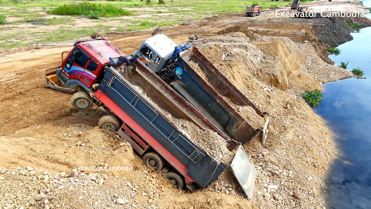 Dump truck that collapsed due to filling soil into a lake. Rescued by a skilled  2 bulldozer driver