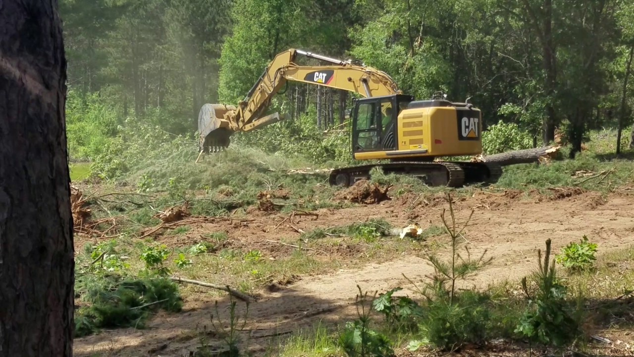 Clearing stumps with Cat 320 excavator