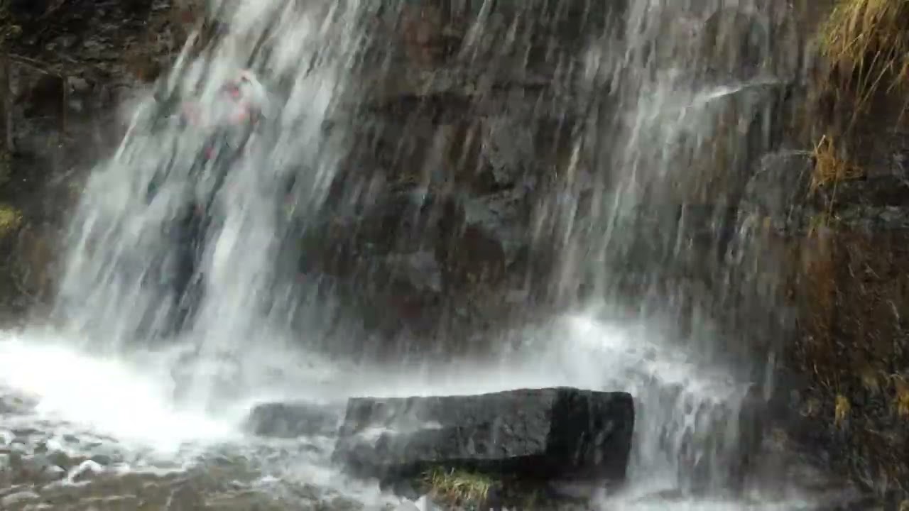 Megan takes a windy rainy walk with a waterfall stop halfway