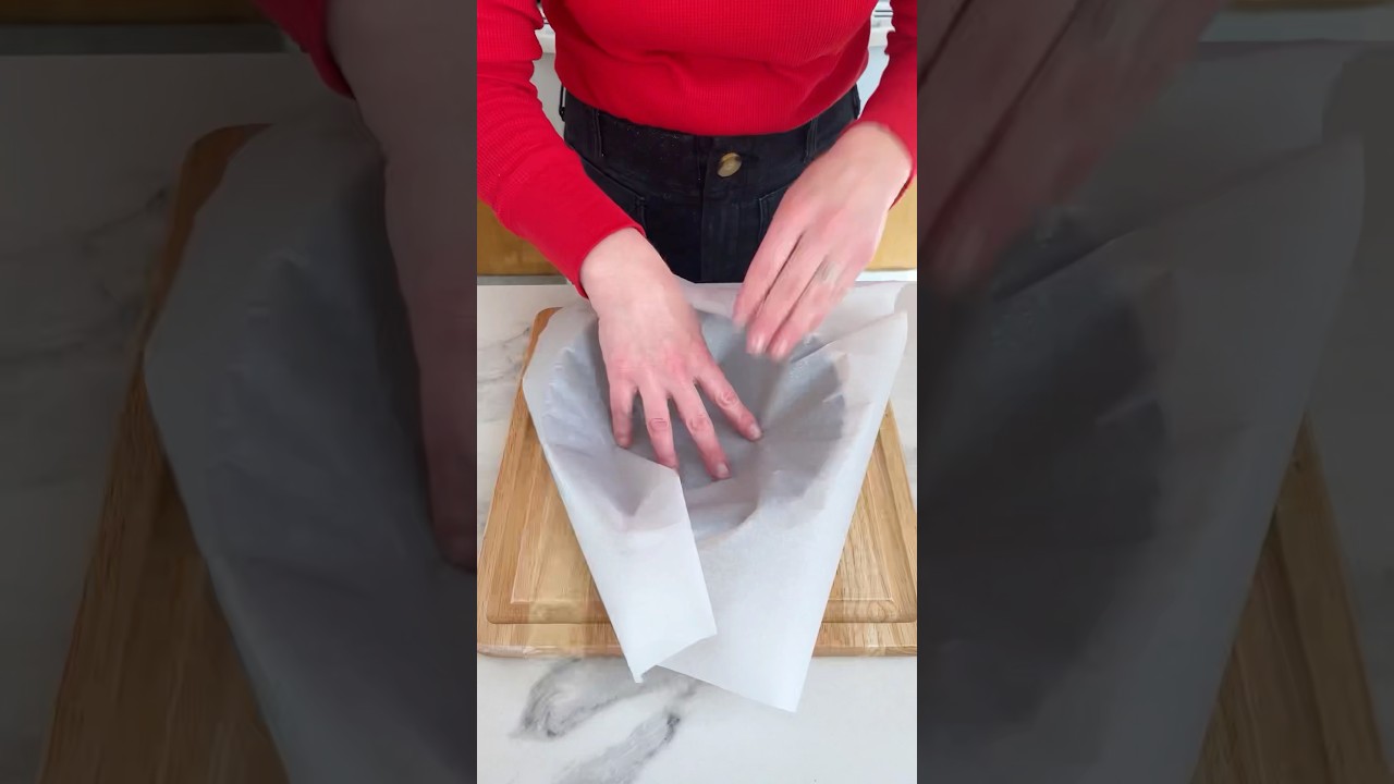 How to make a cartouche! Simple parchment trick for lining round cake pans. #baking #cake