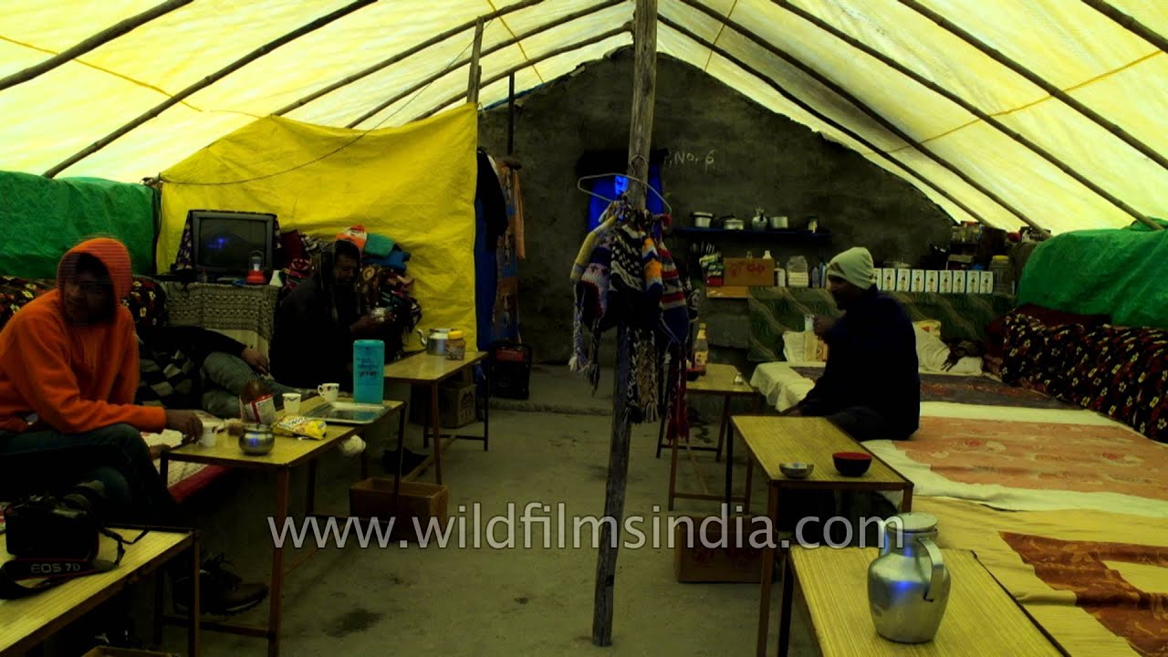 Tourists drink tea at a tented accommodation at Bharatpur en route Ladakh