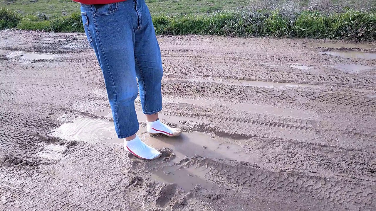 white socks walking on mud