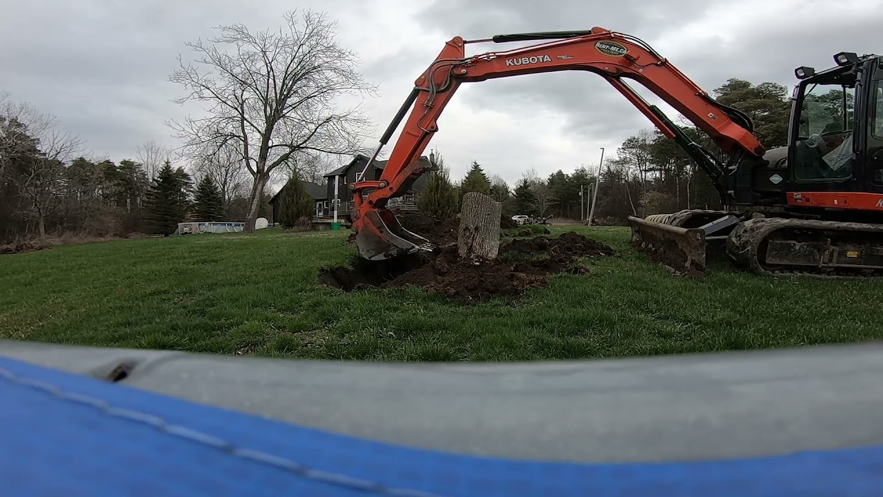 Using a KUBOTA KX080-4 to remove tree stumps