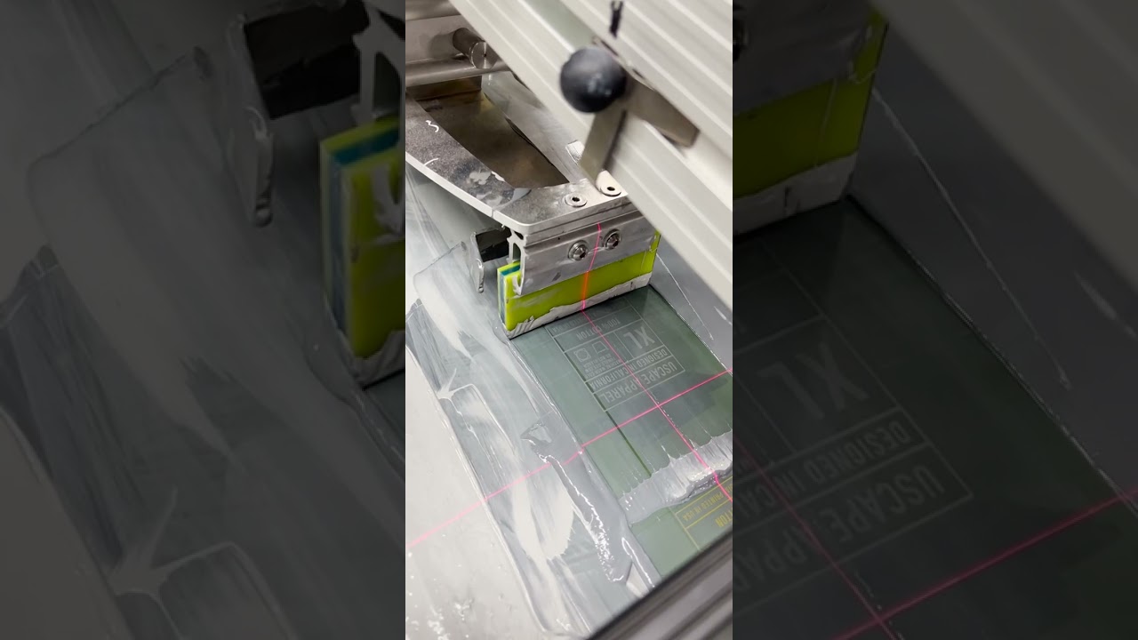 Livingston Systems TAGBOT Prints 100 Tags A Minute on the #ROQYOU #AutomaticScreenPrintingPress 💚🤘