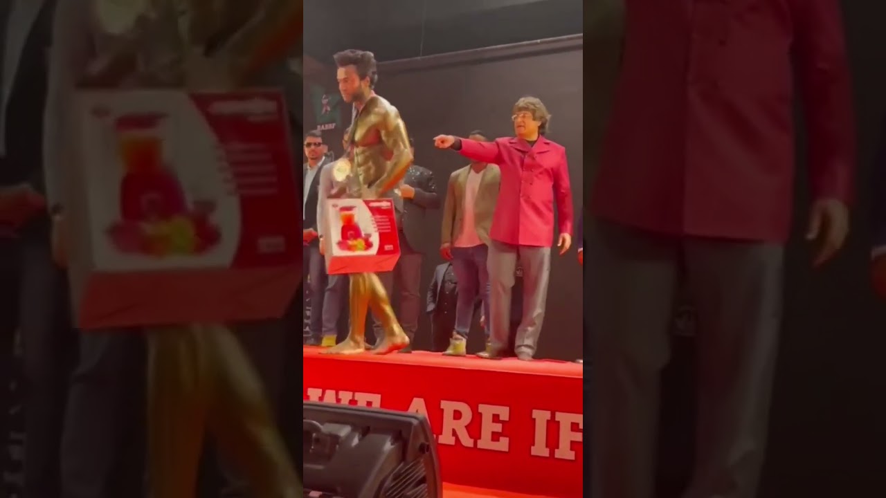 Angry bodybuilder throws his trophy after being insulted.....