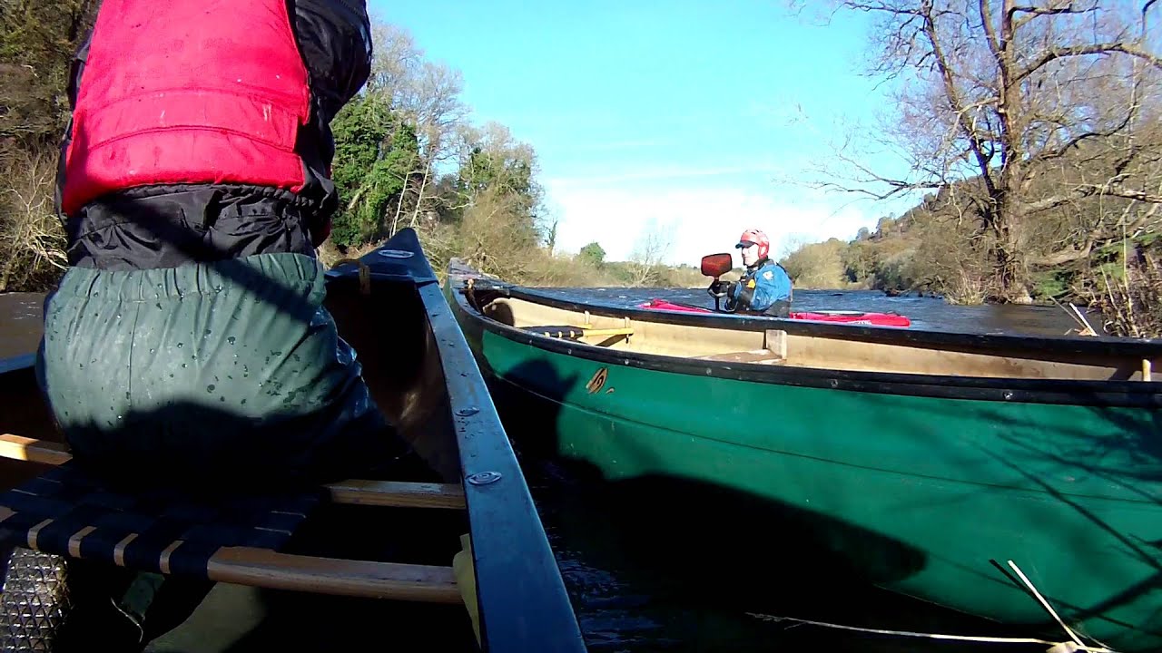 Open Canadian canoe in high winds on the River Wye