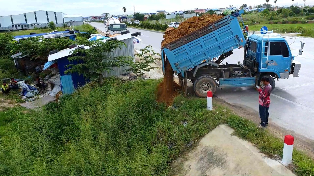 First step: Bulldozer pushes soil to clear ditches along the road.