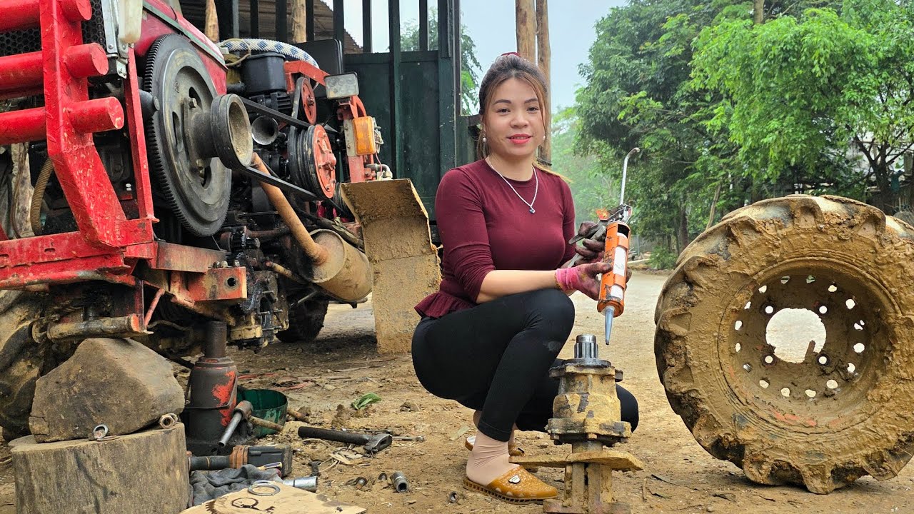 The talented girl: as usual, repairing and replacing the tractor axle bearings.