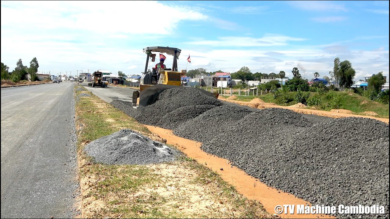 Impressive technique dozer pushing and grading black gravel making foundation new road