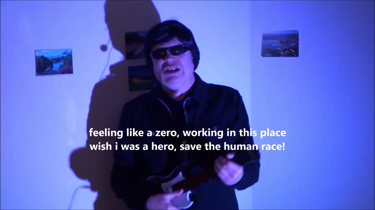 Richard Lavers as rock star Sid Spit singing original song 'Living for the Weekend'.