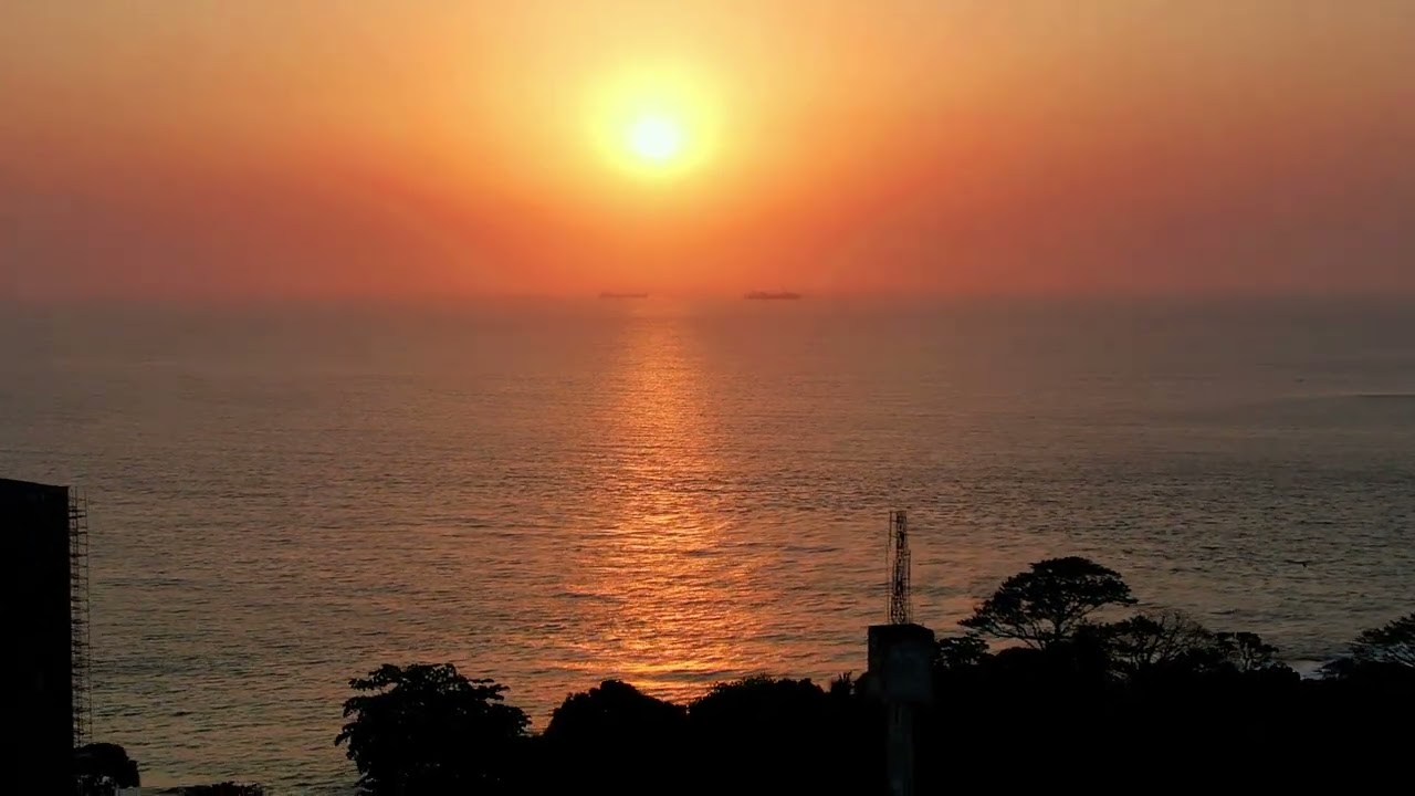 AFRICA -  SUNSET - through the sandy haze of Harmattan.