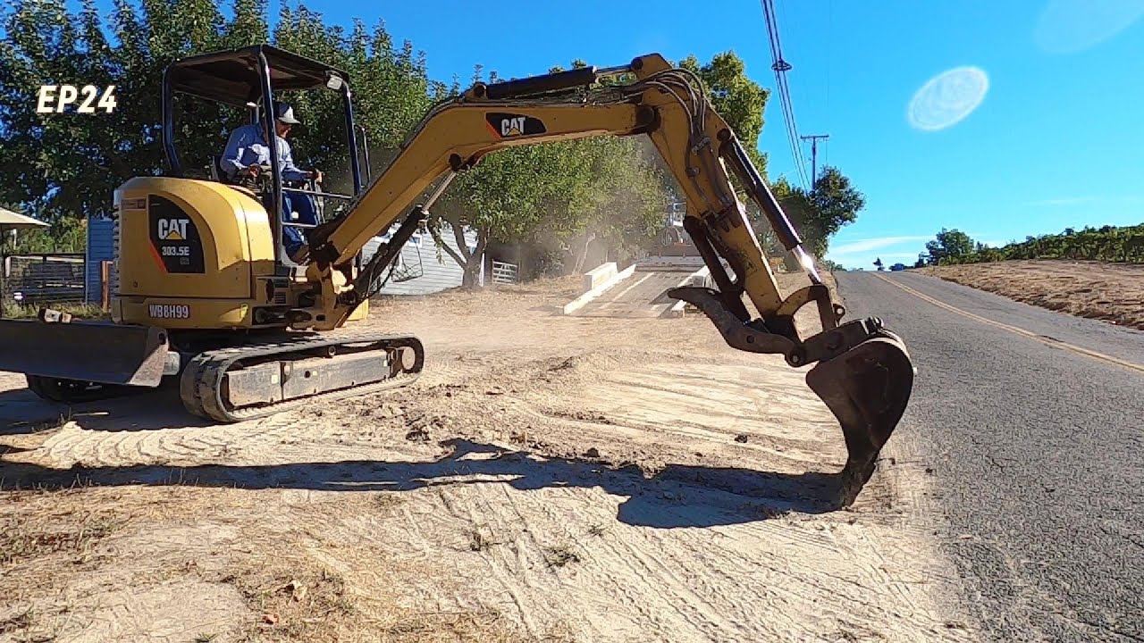 Grading and spreading rock with a mini excavator EP24