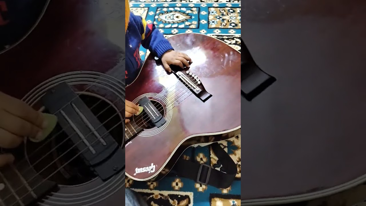 little one playing guitar