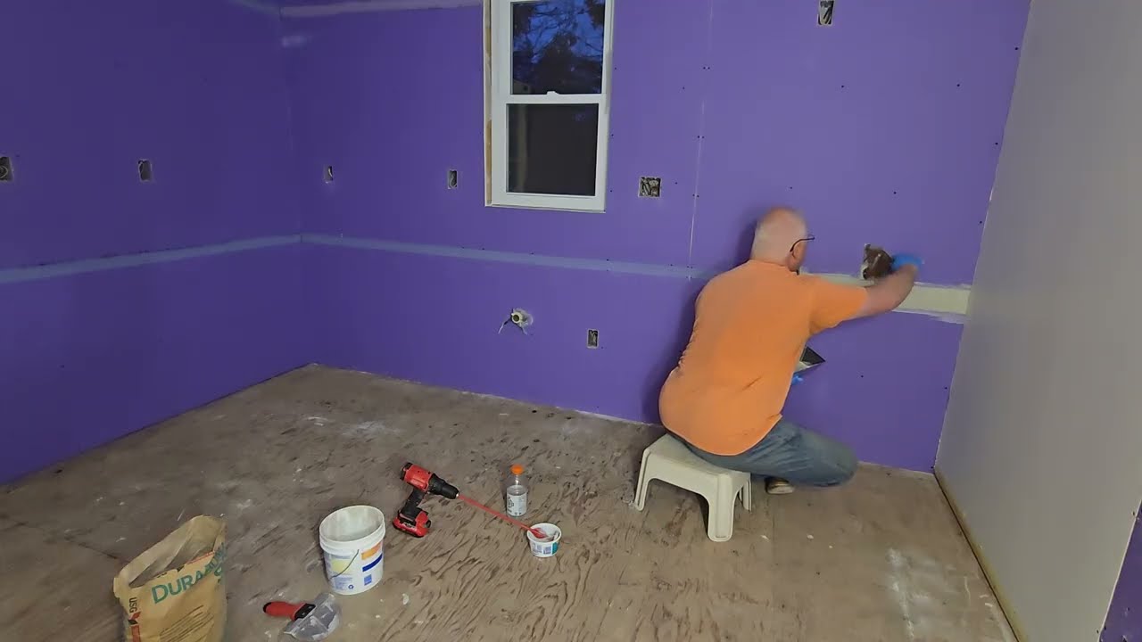 Drywall taping and mudding the horizontal beveled joints in the kitchen