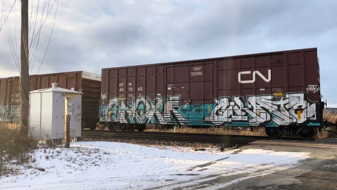 An eastbound freight train and a westbound Charger trainset pass on CN’s Kingston Sub | Dec. 5, 2025