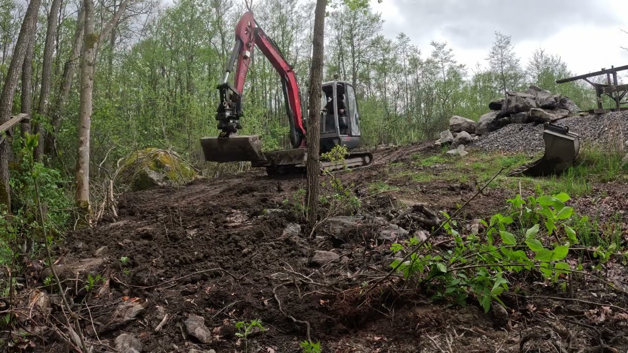 Excavator spreading 200 tons of dirt and clay  on a rainy day, timelapse