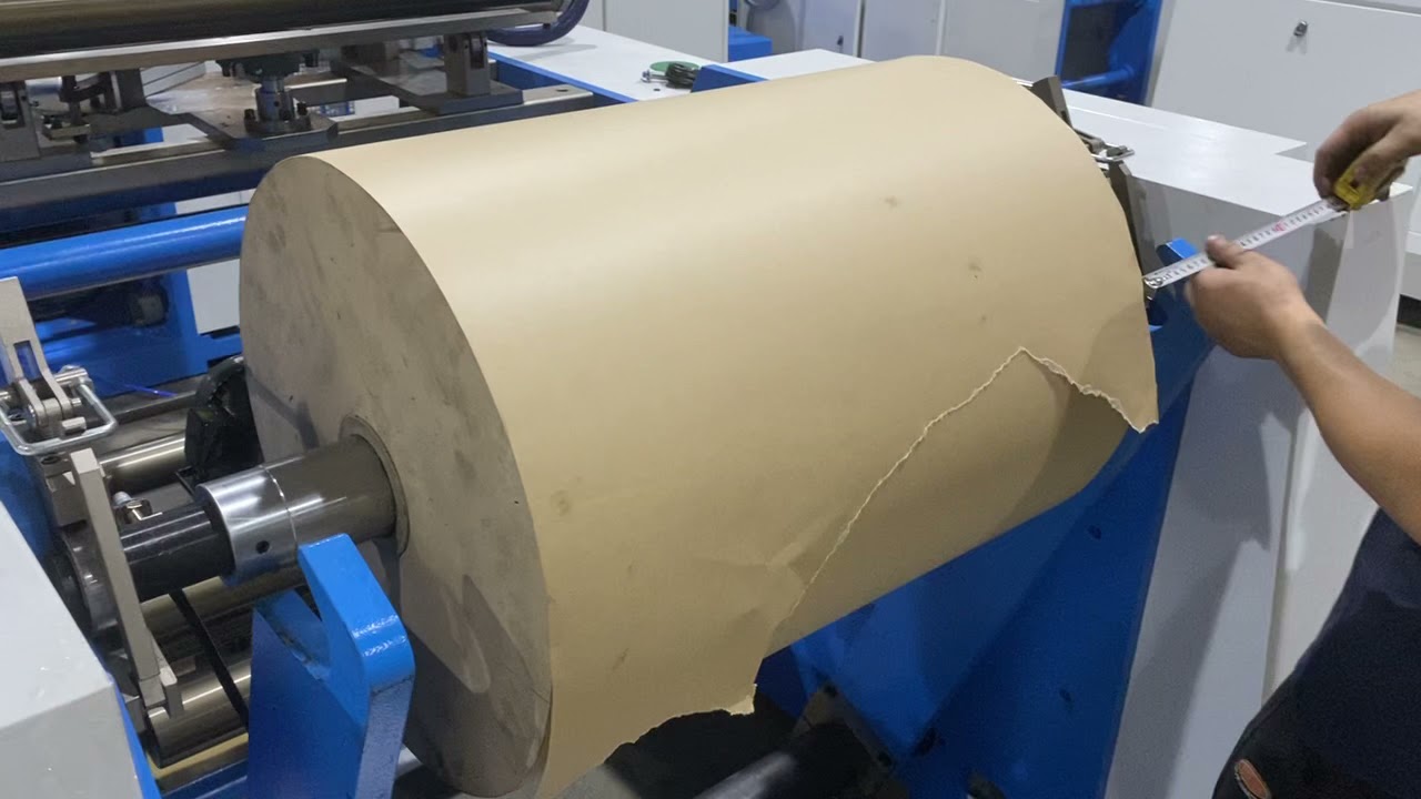 How to load the raw material on paper bag making machine