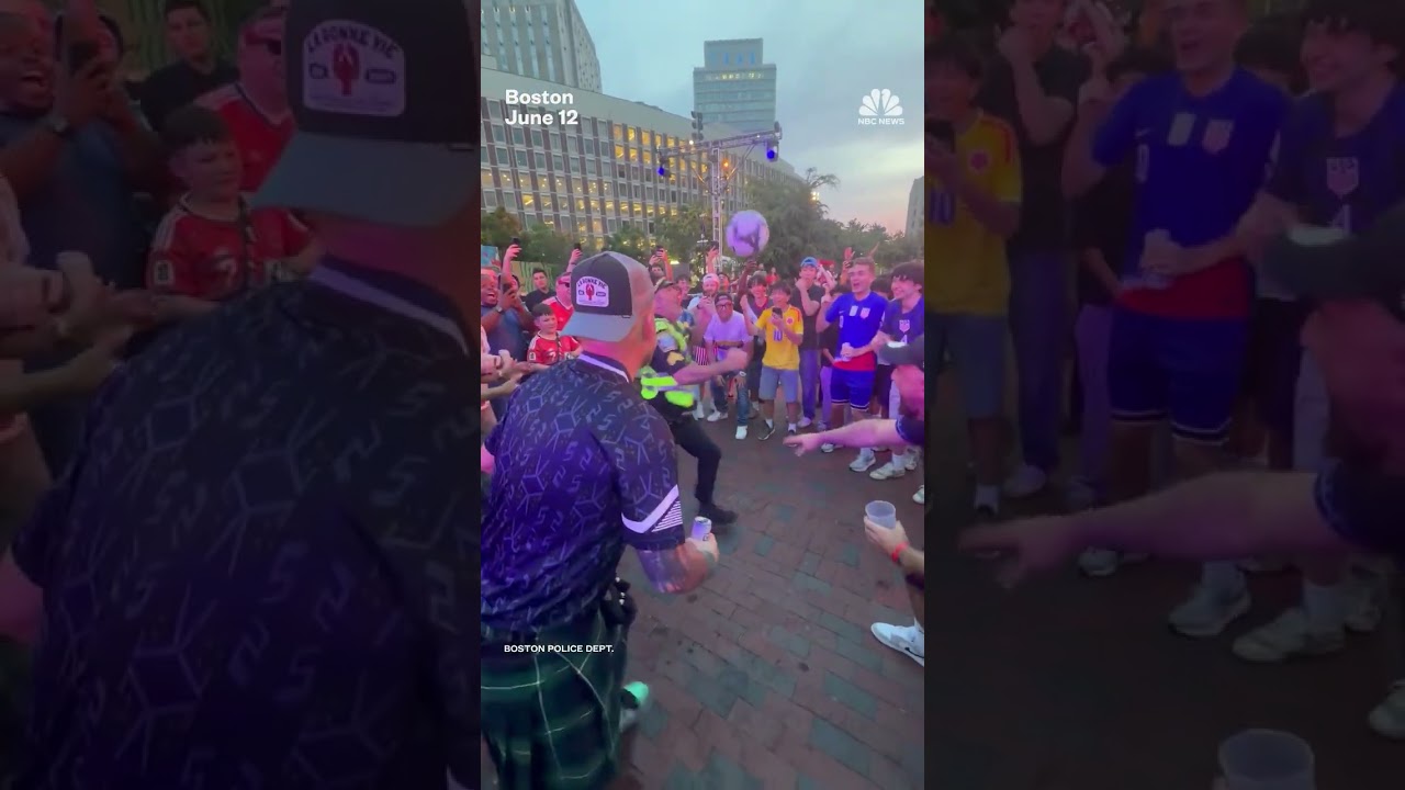 Police officer juggles soccer ball with World Cup fans