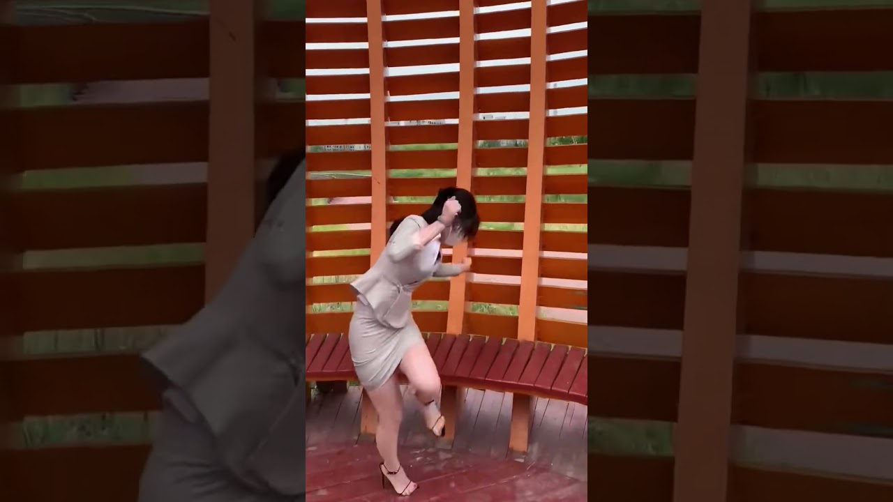 A woman in a business suit and heels inspects a wooden playground #asmr