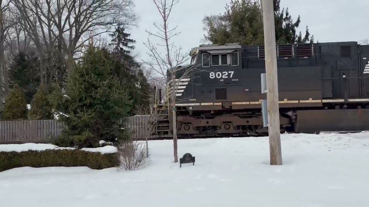 NS 8027 leads NS 315 through elmwood with NS 1101 as a mid train DPU