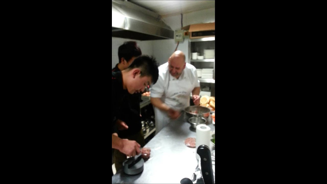 Nick the Greek  makes spicy pork burger live in Beijing .China uk