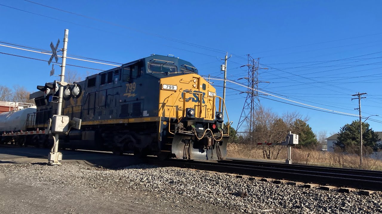 Newly painted CSX 799 pulls a mixed manifest with a DPU
