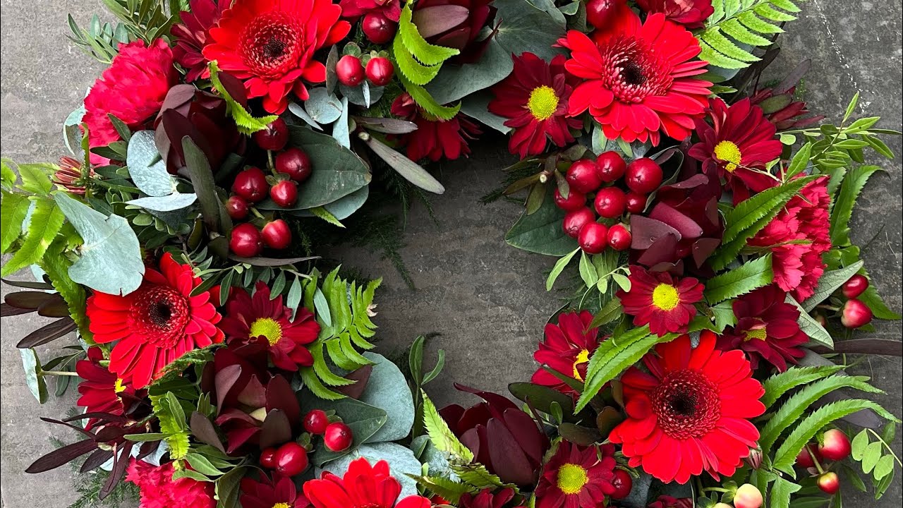 Creating a floral tribute wreath in shades of red and green