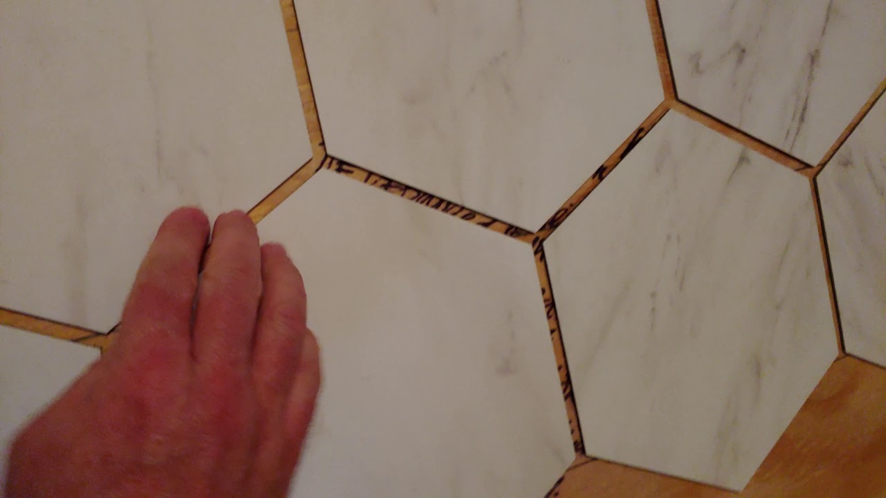 Peel and stick tile coming up fix - use heat!
