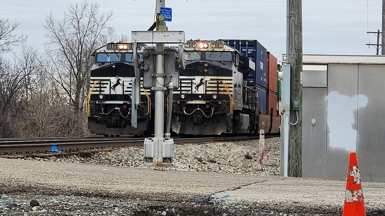 Two Norfolk Southern intermodal trains side by side from startup to finish.