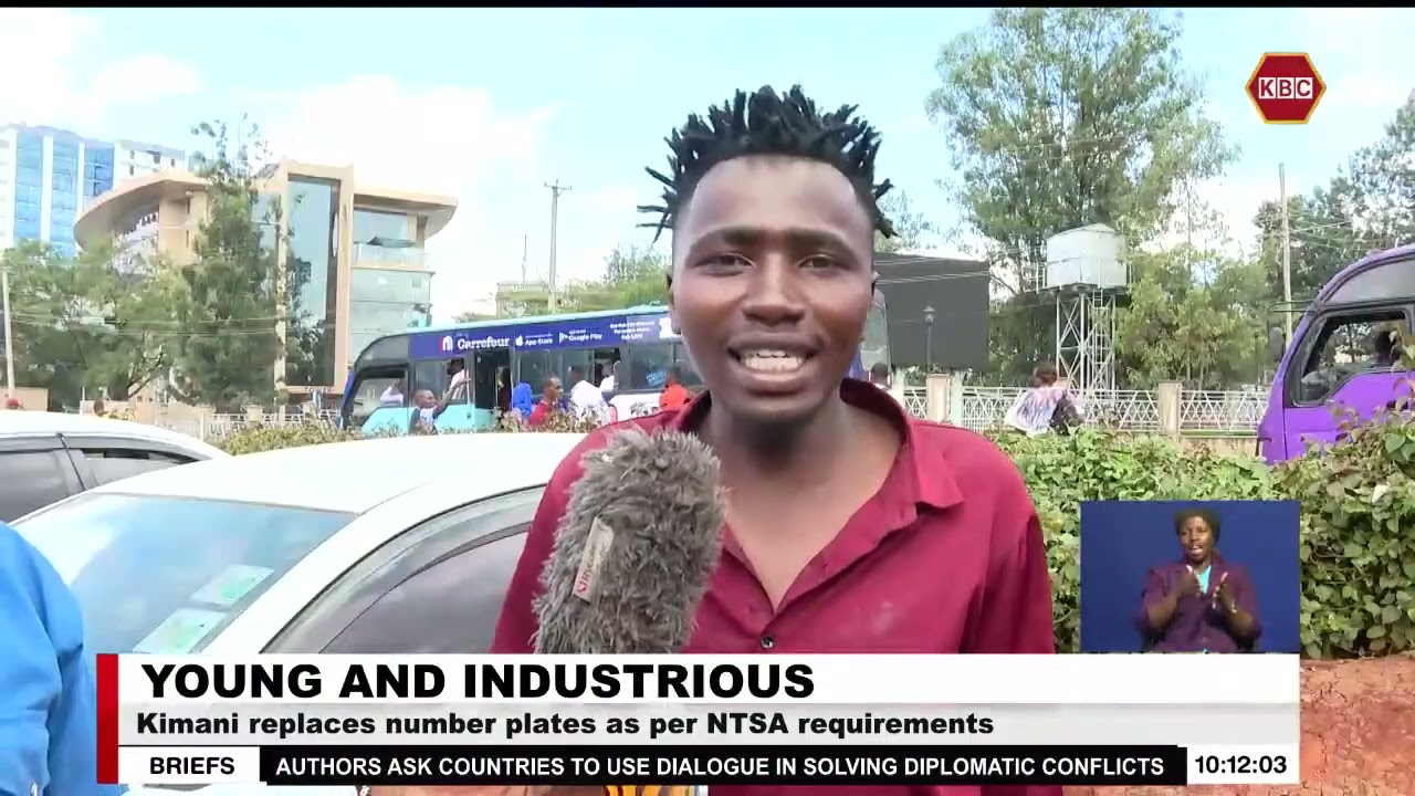 Young & Industrious I Graduate teacher replacing number plates as per NTSA requirements