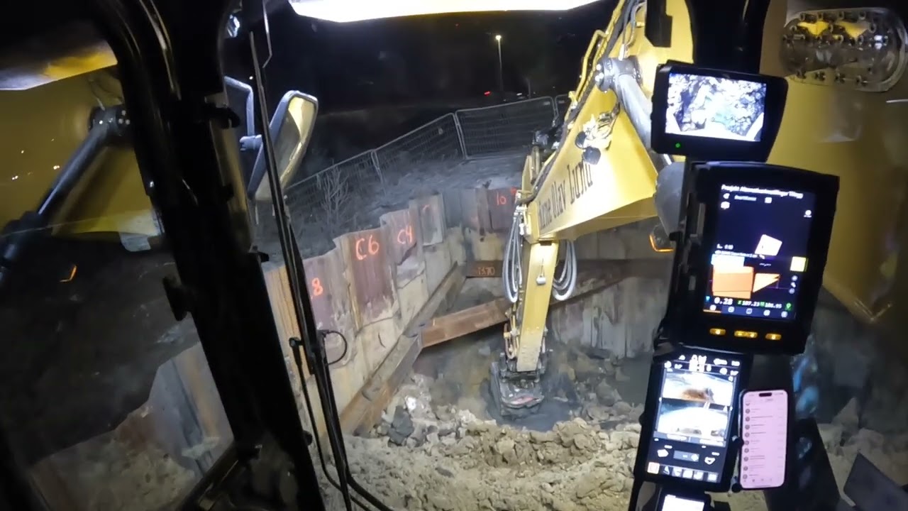 Caterpillar 335 excavator digging out a new sheet pile pite and loading trucks in winter Norway