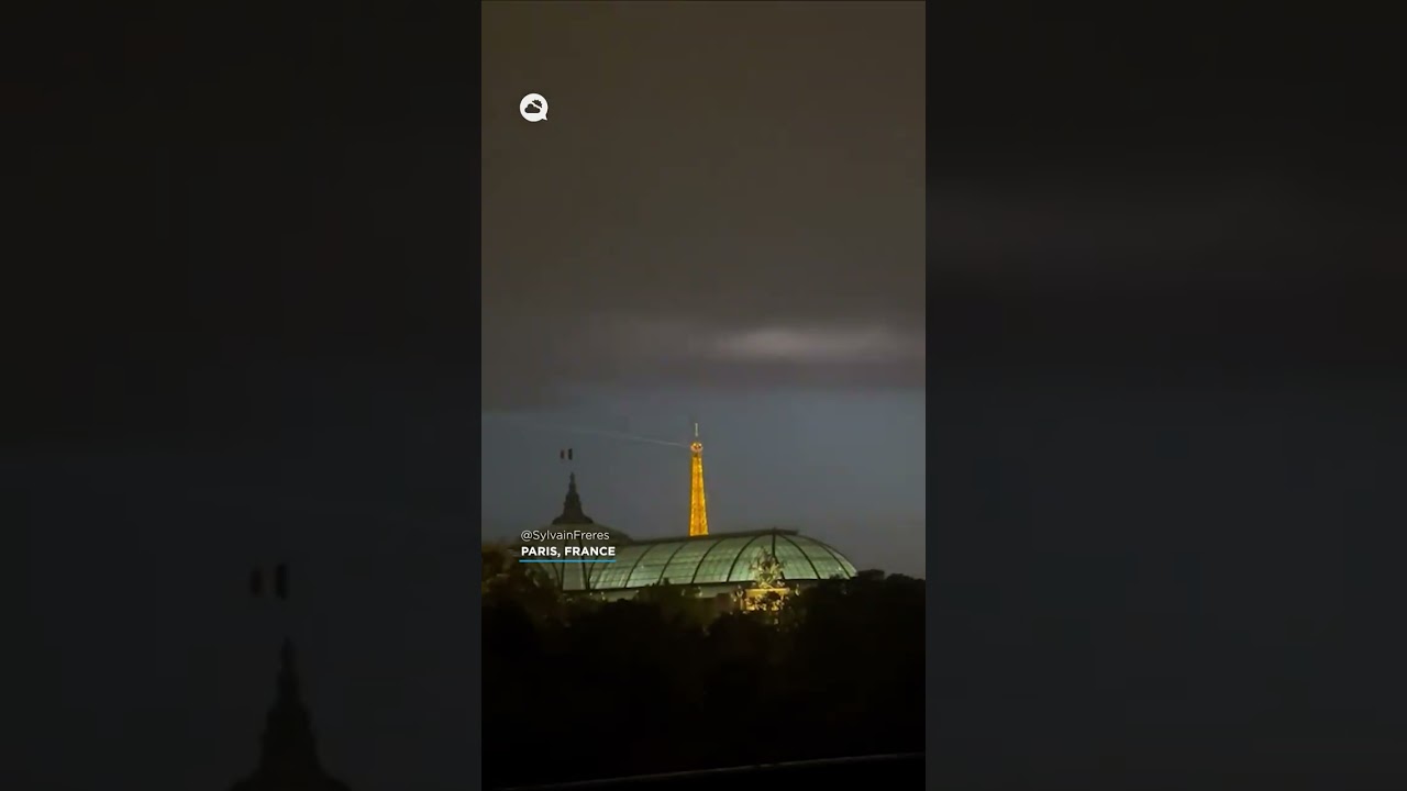 A massive nighttime storm lights up the sky over Paris, France