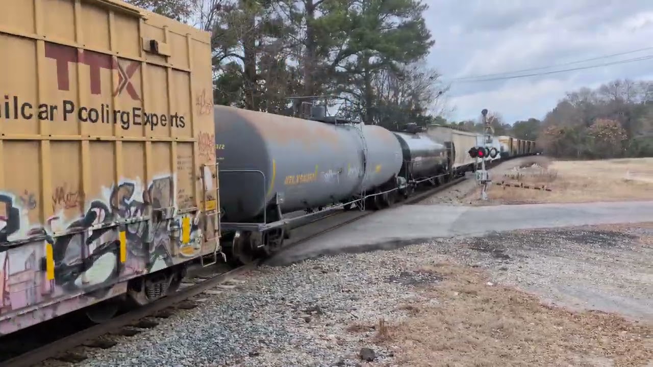 CSX 4789 and CSX 990 lead a good sized south bound mixed freight across Johnson Street 2/19/2026