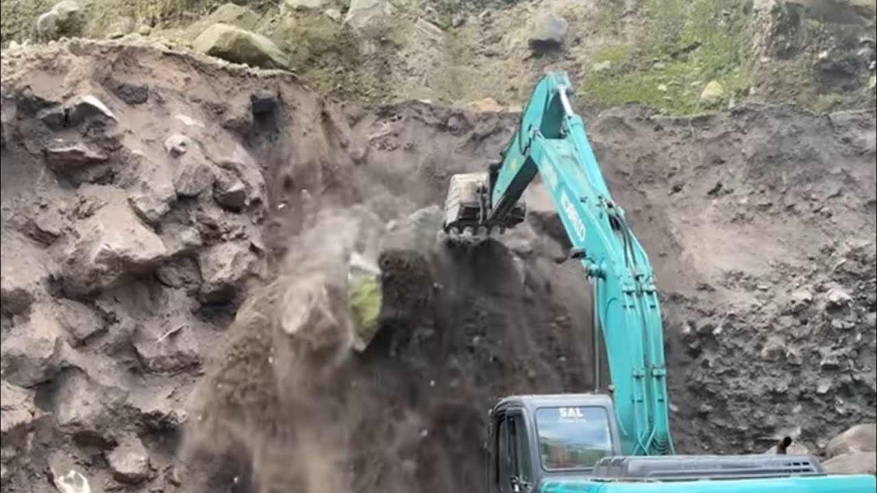 Excavators work digging sand and rock