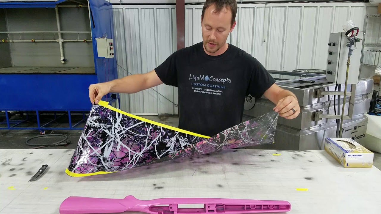 Bryan from Liquid Concepts rolling a gunstock in a pink camo